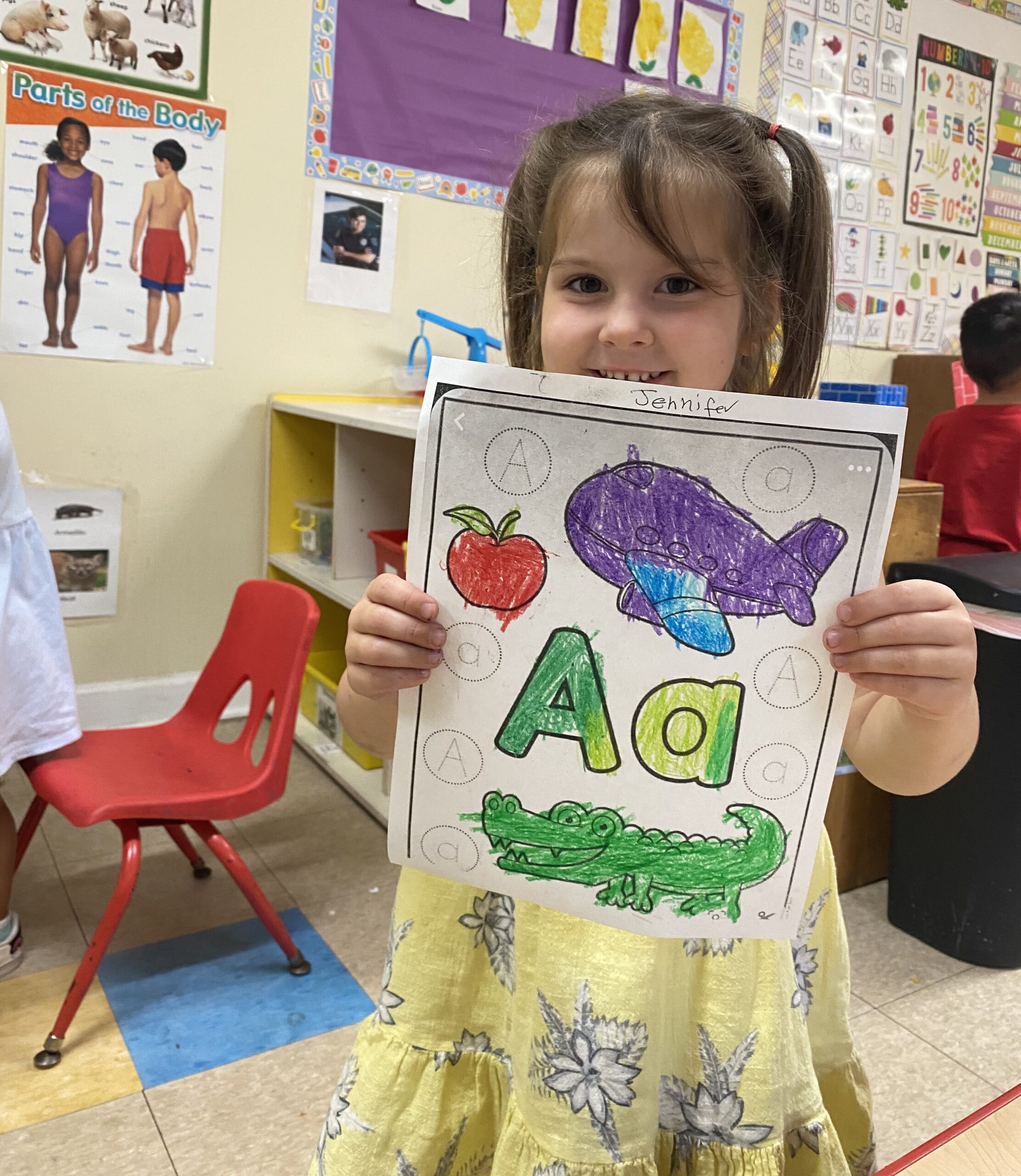 Little girl showing off her coloring skills